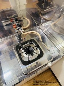 a gas stove sitting on top of a counter at SnowMapleHouse川口 in Kawaguchi +7 photos