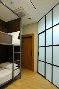 a bunk bed in a room with a door at GAIA Hostel in Türkistan