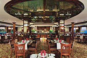a restaurant with tables and chairs and a large ceiling at Sun Nile Cruise in Aswan