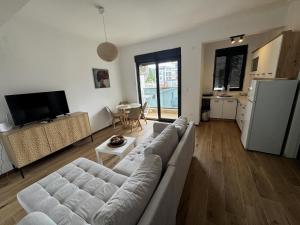 a living room with a couch and a table at Florida Apartments with PARKING in Dobra Voda