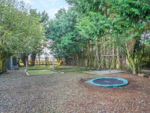 a park with a playground with a trampoline at North Plain Barn in Bowness-on-Solway