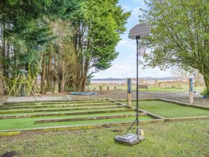 a basketball hoop in a park with a playground at North Plain Barn in Bowness-on-Solway