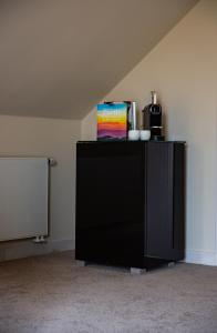 a black cabinet with a box on top of it at Villa Bianca in Dalhem