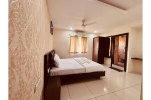 a small bedroom with a bed in a room at FabHotel Udupi in Mysore