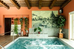 a swimming pool in a house with a painting on the wall at Podere Luna Stella in Bellaria-Igea Marina