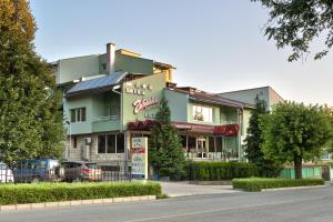 a building with a restaurant on the side of the street at Family Hotel Gabrovo in Gabrovo