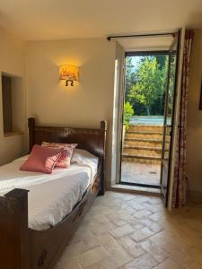 a bedroom with a bed and a sliding glass door at Podere San Pietro in Cetona +12 photos