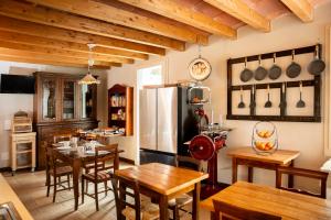 a kitchen with wooden tables and a refrigerator at Podere Luna Stella in Bellaria-Igea Marina