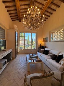 a living room with a couch and a chandelier at Podere San Pietro in Cetona