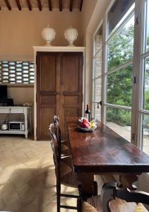 a kitchen with a wooden table with a bowl of fruit on it at Podere San Pietro in Cetona