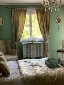 a bedroom with a bed and a window at Les Menendos in Saint-Jean-de-Barrou +35 photos