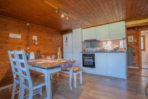 a kitchen with a table and chairs in a room at Cosy Chalet in Brig-Glis in Glis