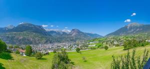 a green valley with mountains in the background at Cosy Chalet in Brig-Glis in Glis