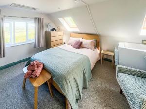 a bedroom with a large bed and a window at Bay Tree in Sturminster Newton