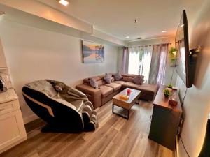 a living room with a couch and a tv at The Classic Suite: 2BR close to NYC in Paterson