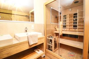 a bathroom with a sink and a mirror at Apartment ZellPeak in Zell am See +15 photos