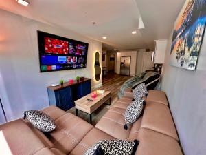 a living room with a couch and a tv at The Classic Suite: 2BR close to NYC in Paterson