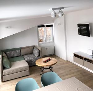 ein Wohnzimmer mit einem Sofa und einem Tisch in der Unterkunft Cucagna in Disentis