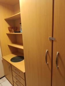 a closet with a wooden cabinet and a sink at Oceanview Apart Residence in Natal +10 photos