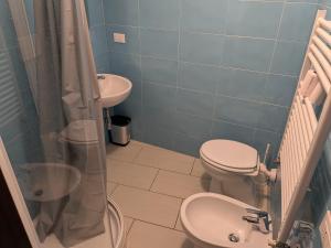 a bathroom with a toilet and a sink at Affittacamere Pietra Lucente in Riomaggiore +6 photos