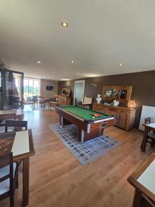 a living room with a pool table in it at Les Portes d'Apcher in Saint-Chély-dʼApcher