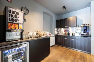 a kitchen with a large counter with a food warmer at Hotel Wetterstein by keyone in Seefeld in Tirol
