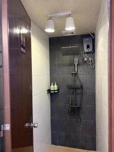 a bathroom with a shower with a brown door at La Paula Hostel in San Juan