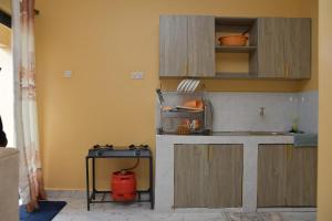 a kitchen with a fire hydrant in the corner at Maria VillaSTUDIO2 in Voi