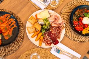 a wooden table with plates of food on it at Le Refuge du Grand Hôtel - Altitude 1900 m - Accès Cabine - Cabin Access in Saint-Chaffrey +45 photos