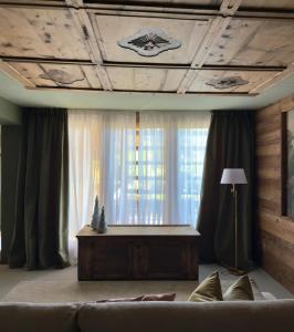 a living room with a couch and a window at Tessenberg Mountain Retreat in Heinfels