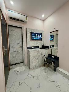 a room with a desk and a television on a wall at Hotel Classy Comfort Business Family Hotel in Mumbai