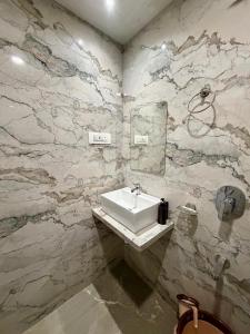 a bathroom with a sink and a mirror at Hotel Classy Comfort Business Family Hotel in Mumbai