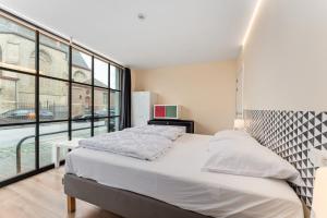 a bedroom with a large bed and a large window at Barbara' s Guesthouse in Watou +45 photos