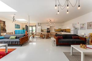 a living room with couches and a dining room at Barbara' s Guesthouse in Watou