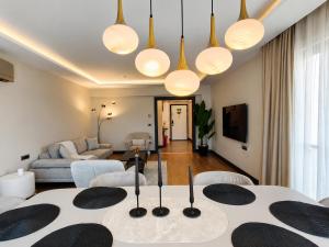 a living room with a table and a couch at Utopia Suite Residence1 in Burunabat +32 photos