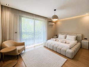 a bedroom with a large bed and a large window at Utopia Suite Residence1 in Burunabat