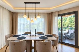 a dining room with a table and chairs at Utopia Suite Residence1 in Burunabat