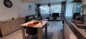 a kitchen and living room with a table and a counter top at Charmant studio à Castillon du Gard, à deux pas du Pont-du-Gard in Castillon-du-Gard