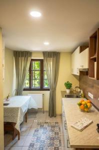 a kitchen with a bed and a sink in a room at Under Rock Guesthouse in Bled