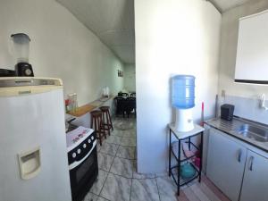 a kitchen with a stove and a sink and a kitchen with at Flat Centro Rota Cachoeira in Bonito