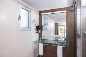 a bathroom with a sink and a mirror at RVHotels Nautic Park in Platja d'Aro
