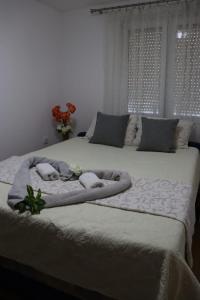 a bedroom with two beds with towels on them at Apartman Anastasija in Guča +36 photos