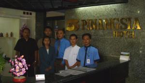 a group of people standing in front of a hotel at Hotel Pinangsia in Jakarta