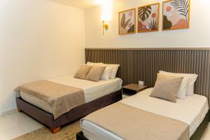 a hotel room with two beds in a room at Horizonte del Mar Hotel Boutique in Santa Marta +21 photos