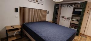 a bedroom with a large bed in a room at Charmant studio à Castillon du Gard, à deux pas du Pont-du-Gard in Castillon-du-Gard