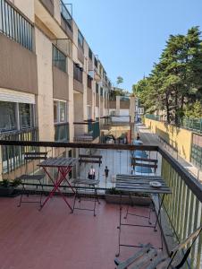 a patio with tables and chairs on a balcony at Travel & Live Marques in Porto