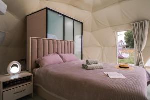 a bedroom with a large bed in a tent at Nomad Space in Bar-Bulak