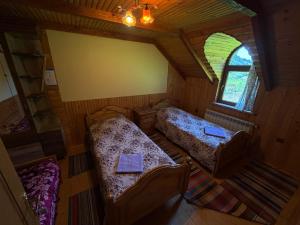 an overhead view of a bedroom with two beds and a window at Shelest Vody in Russkaya Mokraya