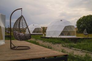 a couple of white tents in a field at Nomad Space in Bar-Bulak