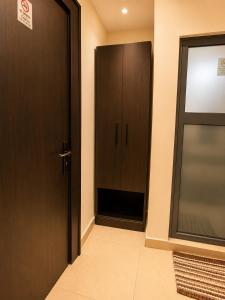 a hallway with a door and a cabinet at Westside Beach Resort & Hotel in Mopo Akinlade
